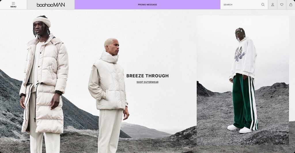 Desktop BoohooMAN homepage with a campaign image and shop outerwear.